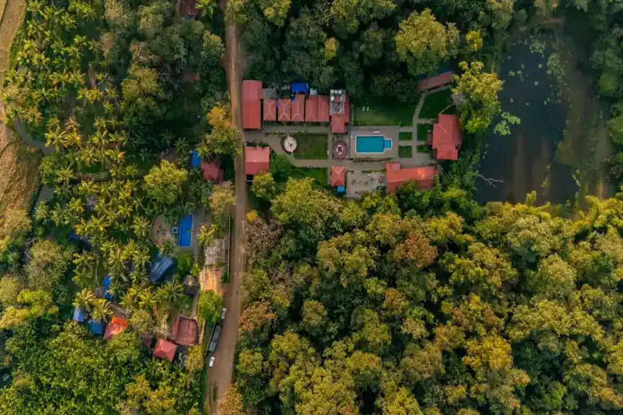 Top-down aerial view of Wild Mist resort layout surrounded by forest in Dandeli