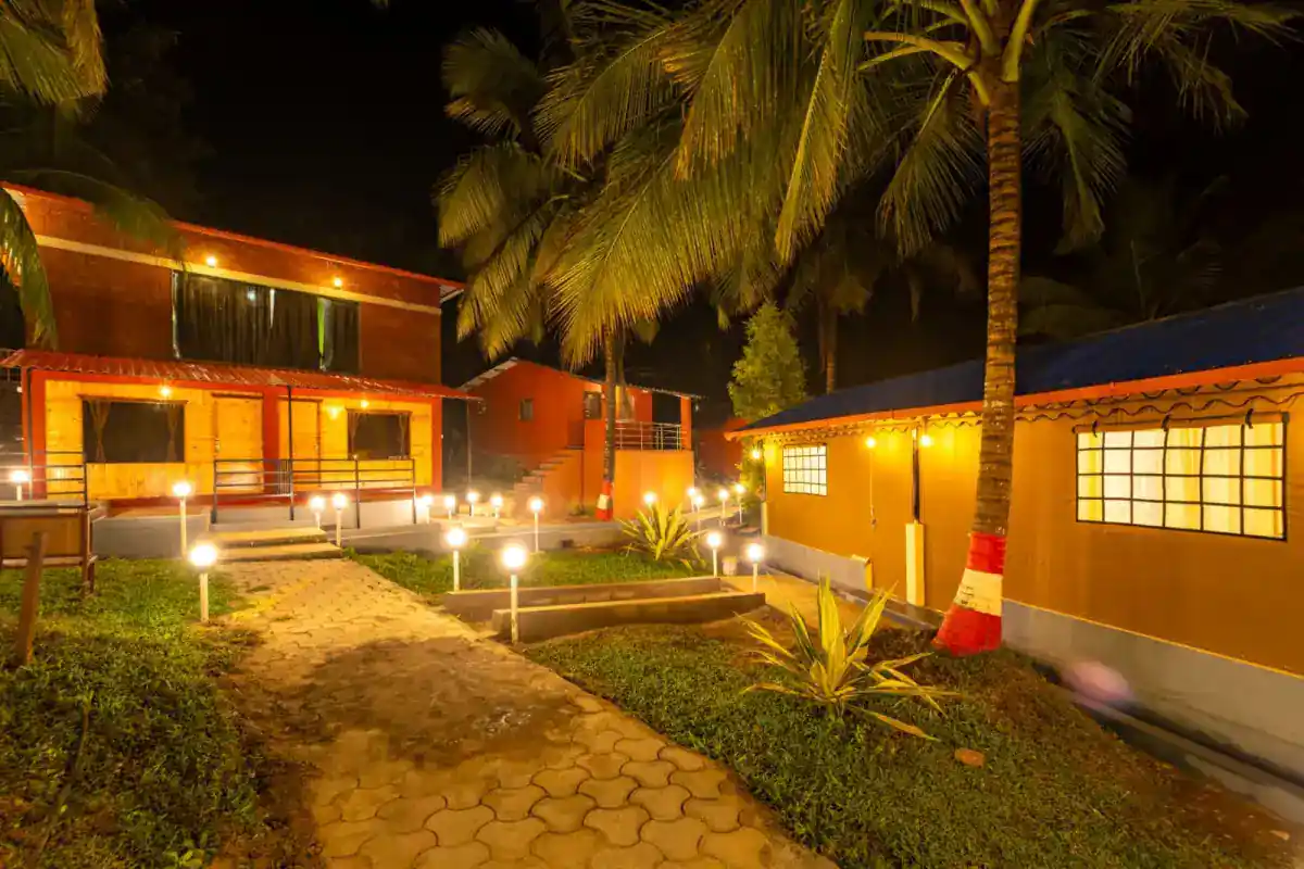 Garden pathway through lush greenery at Wild Mist Jungle Stay Dandeli